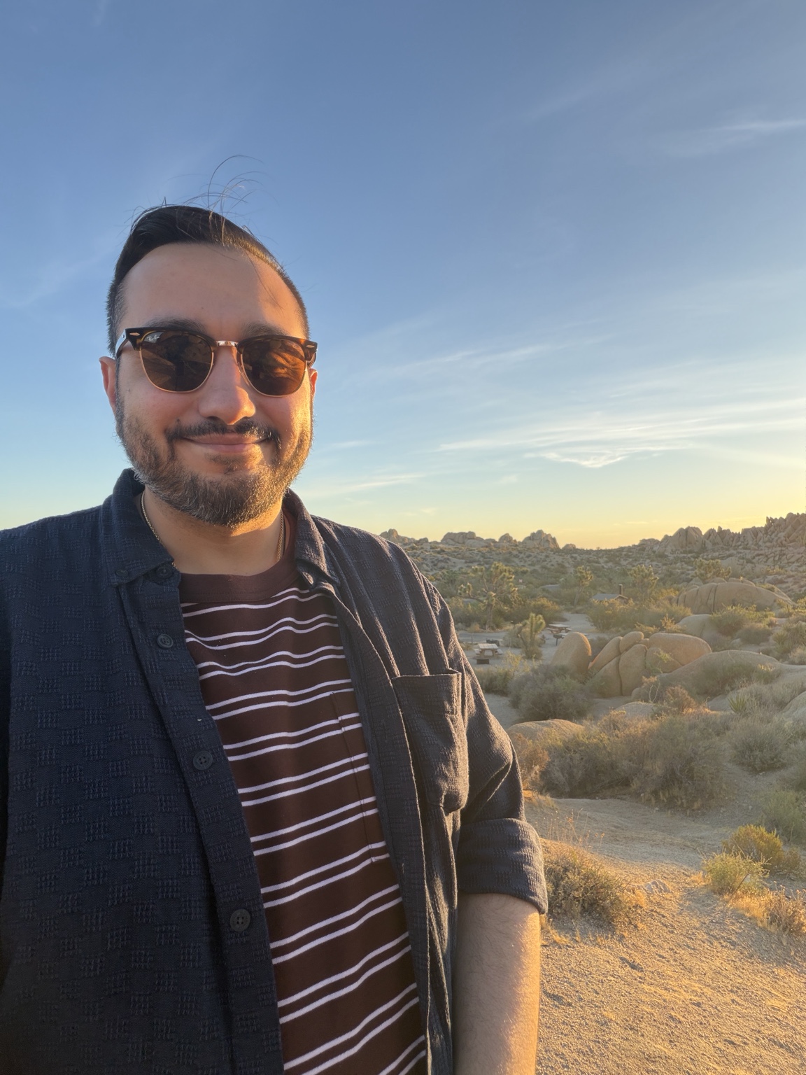 Mike Basso outdoors in a rocky desert landscape at sunset
